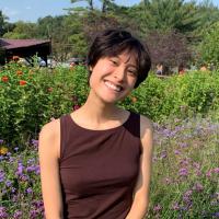 Alena Zhang standing in front of Flowers